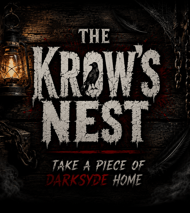 Logo graphic reading 'THE KROW'S NEST TAKE A PIECE OF DARKSYDE HOME' in distressed white and red font with a crow perched inside the text, set against a dark rustic wooden background with a lit vintage lantern, chains, and cobwebs.